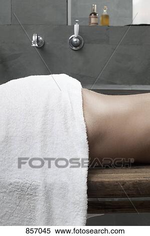 A woman lying down in a health spa bathroom, midsection View Large Photo Image Stock Photography - A woman lying down in a health spa bathroom, midsection. Fotosearch