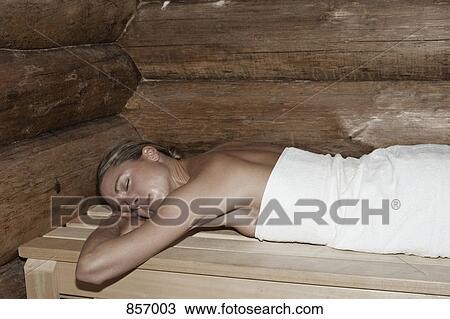 A woman lying on her front in a sauna View Large Photo Image Stock Image - A woman lying on her front in a sauna. Fotosearch