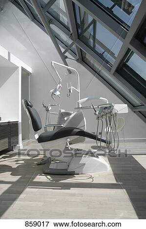Stock Photo - An empty chair in a dental examination room. Fotosearch