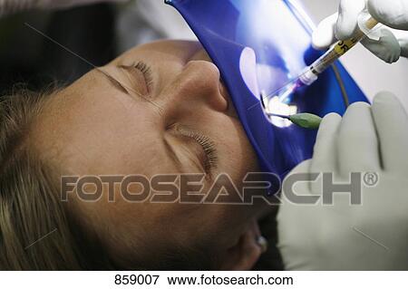 Close-up of a dental patient receiving an injection View Large Photo Image Stock Photo - Close-up of a dental patient receiving an injection. Fotosearch
