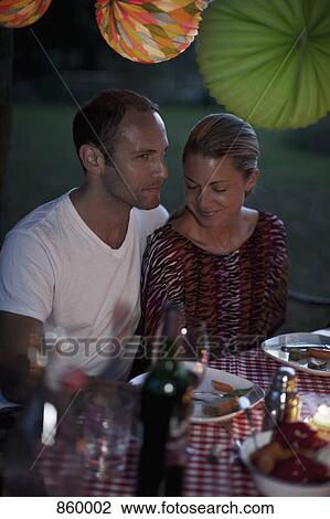 A couple at a dinner party, outdoors, night View Large Photo Image Stock Image - A couple at a dinner party, outdoors, night. Fotosearch