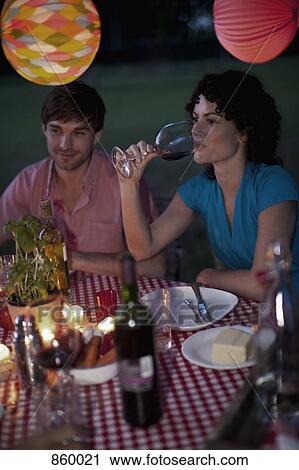 A couple at a dinner party, outdoors View Large Photo Image Stock Image - A couple at a dinner party, outdoors. Fotosearch