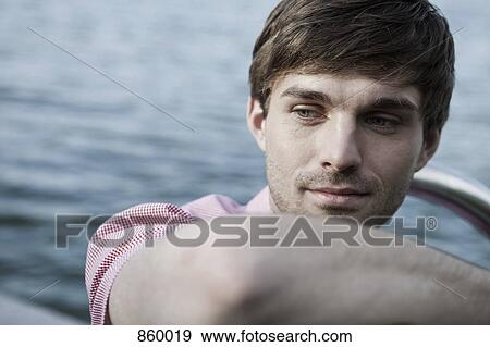 A man relaxing by a lake, head and shoulders View Large Photo Image Stock Photo - A man relaxing by a lake, head and shoulders. Fotosearch