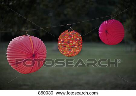 Three paper lanterns hanging from a clothesline View Large Photo Image Stock Image - Three paper lanterns hanging from a clothesline. Fotosearch