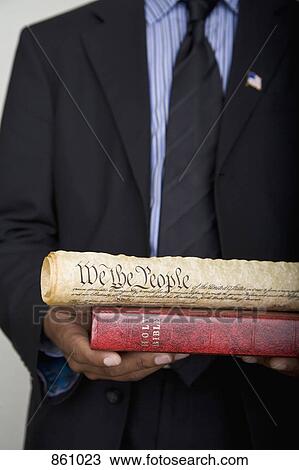 Detail of a man holding a Bible and a scroll of the American Constitution View Large Photo Image Stock Image - Detail of a man holding a Bible and a scroll of the American Constitution. Fotosearch