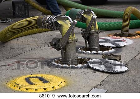 Detail of pipes connected to pumps in the ground View Large Photo Image Stock Photo - Detail of pipes connected to pumps in the ground. Fotosearch