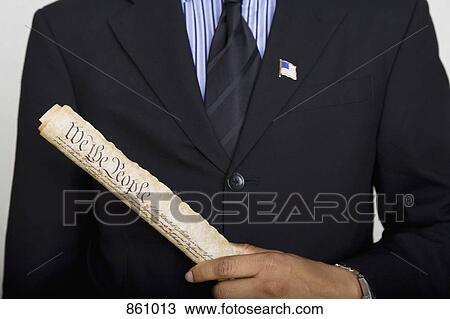 Midsection of a man holding a copy of the US Constitution View Large Photo Image Stock Image - Midsection of a man holding a copy of the US Constitution. Fotosearch