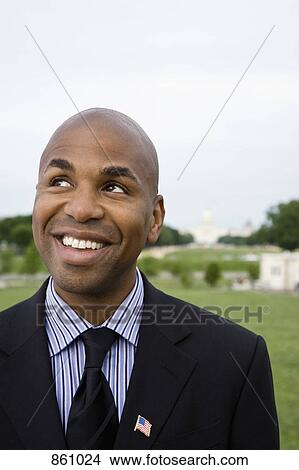 Picture - Portrait of a well dressed man smiling and looking away, Washington DC, USA. Fotosearch