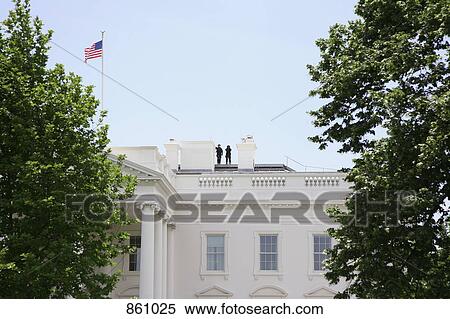 Stock Photography - Two people standing on the roof of the Whitehouse, Washington DC, USA. Fotosearch