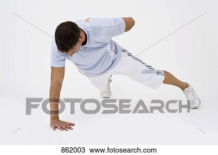 A man doing a one-arm push-up View Large Photo Image Stock Image - A man doing a one-arm push-up. Fotosearch