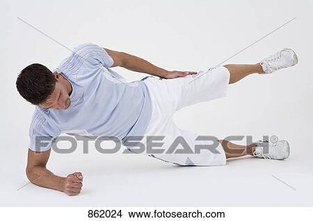 A man leaning on his side and stretching View Large Photo Image Picture - A man leaning on his side and stretching. Fotosearch