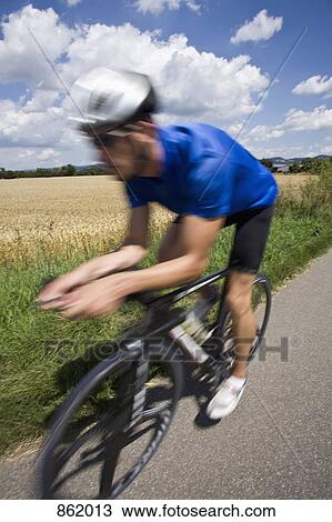 A man riding a bicycle View Large Photo Image Stock Image - A man riding a bicycle. Fotosearch