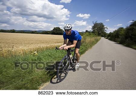 A man riding a bicycle View Large Photo Image Stock Image - A man riding a bicycle. Fotosearch