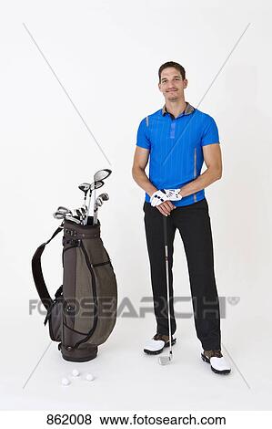 A man standing with golfing equipment View Large Photo Image Stock Photo - A man standing with golfing equipment. Fotosearch