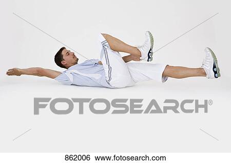 A man stretching on the floor View Large Photo Image Stock Photograph - A man stretching on the floor. Fotosearch