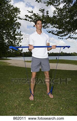 A man using doing pilates in a park View Large Photo Image Stock Image - A man using doing pilates in a park. Fotosearch