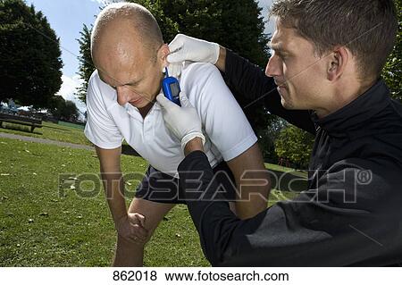 A personal trainer taking the temperature of man View Large Photo Image Stock Photo - A personal trainer taking the temperature of man. Fotosearch