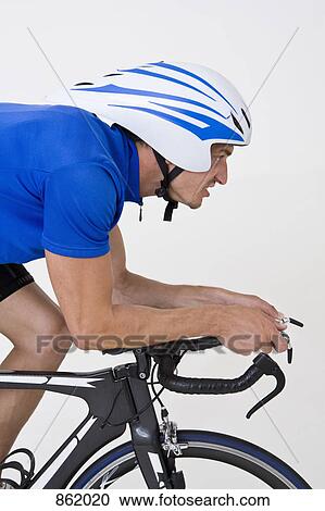 Stock Image - Detail of a cyclist on a bike. Fotosearch