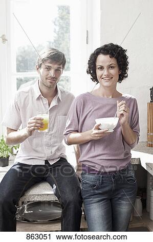 A couple having breakfast in the kitchen View Large Photo Image Stock Image - A couple having breakfast in the kitchen. Fotosearch