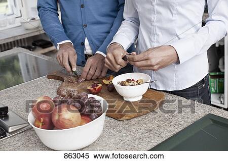 A couple preparing fruit together View Large Photo Image Stock Photography - A couple preparing fruit together. Fotosearch