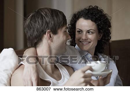 A couple smiling and embracing View Large Photo Image Stock Photo - A couple smiling and embracing. Fotosearch