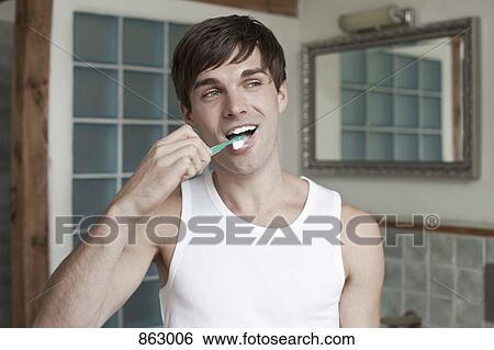Stock Photograph - A man brushing his teeth. Fotosearch