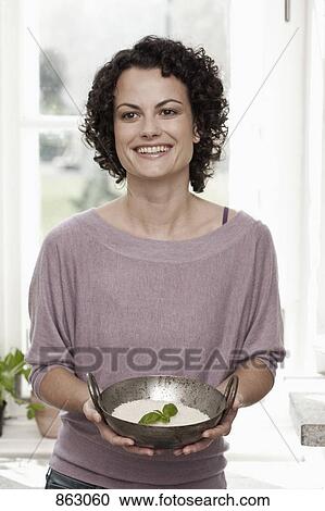 A woman holding a bowl of rice View Large Photo Image Stock Image - A woman holding a bowl of rice. Fotosearch