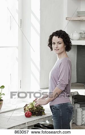 A woman preparing vegetables View Large Photo Image Stock Photo - A woman preparing vegetables. Fotosearch