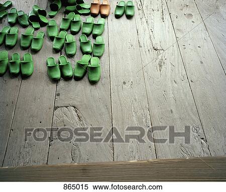 Pairs of slippers on a wooden floor View Large Photo Image Stock Photography - Pairs of slippers on a wooden floor. Fotosearch