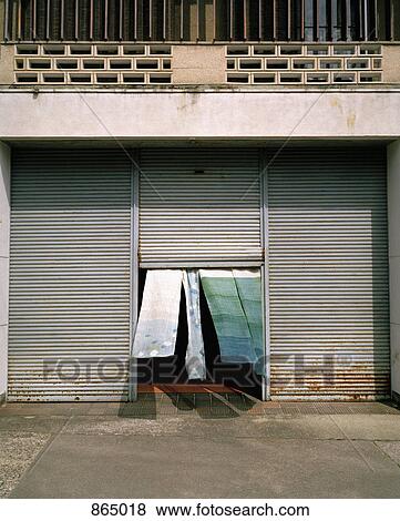 Pieces of fabric flapping from an open rolling door View Large Photo Image Stock Photo - Pieces of fabric flapping from an open rolling door. Fotosearch