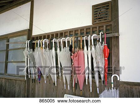Various umbrellas hanging from railing View Large Photo Image Stock Photography - Various umbrellas hanging from railing. Fotosearch
