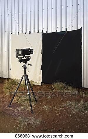 Stock Image - A camera and back drop set up outdoors. Fotosearch