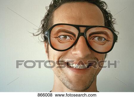 Stock Photo - A man wearing novelty glasses and smiling. Fotosearch