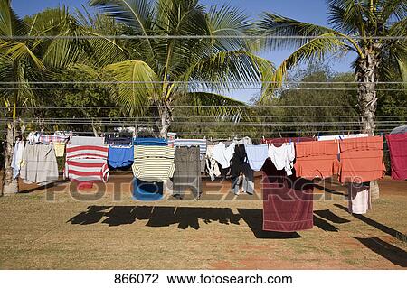 Stock Image - Clean clothes hanging on a washing line, Eighty Mile Beach, Western Australia, Australia. Fotosearch