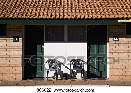 Stock Image - Exterior view of two motel rooms. Fotosearch