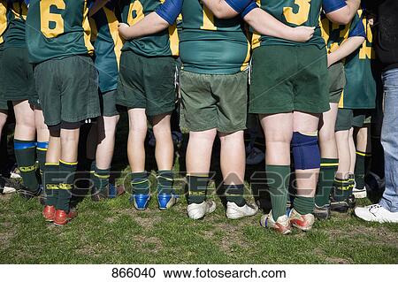 Rear view of a football team huddled together View Large Photo Image Stock Image - Rear view of a football team huddled together. Fotosearch