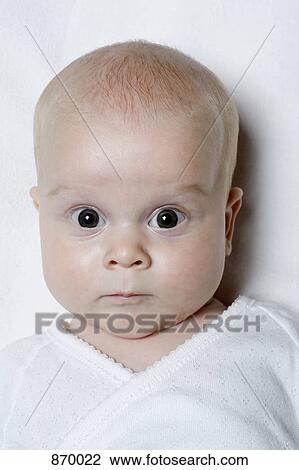 Stock Image - A baby looking surprised, portrait. Fotosearch