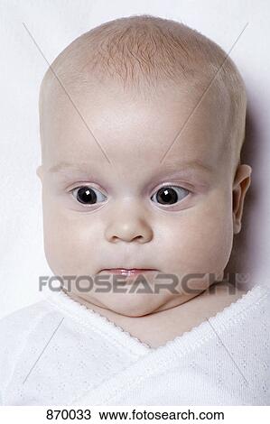 Stock Image - A baby looking surprised, portrait. Fotosearch