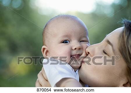 A mother kissing her baby boy View Large Photo Image Picture - A mother kissing her baby boy. Fotosearch