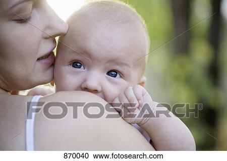A mother kissing her baby boy View Large Photo Image Stock Image - A mother kissing her baby boy. Fotosearch