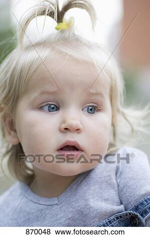 A toddler with a look of curiosity, looking away, portrait View Large Photo Image Stock Photo - A toddler with a look of curiosity, looking away, portrait. Fotosearch