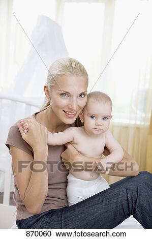 A woman and her baby in a nursery View Large Photo Image Stock Image - A woman and her baby in a nursery. Fotosearch
