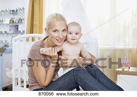 A woman and her baby in a nursery View Large Photo Image Stock Photograph - A woman and her baby in a nursery. Fotosearch