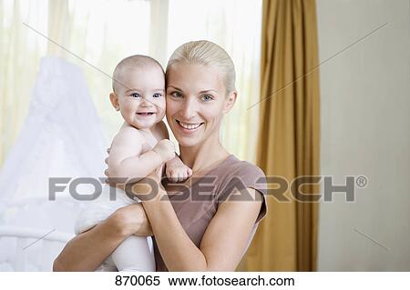 A woman and her baby in a nursery View Large Photo Image Stock Photography - A woman and her baby in a nursery. Fotosearch