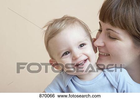 A woman and her baby, portrait, studio shot View Large Photo Image Stock Photograph - A woman and her baby, portrait, studio shot. Fotosearch