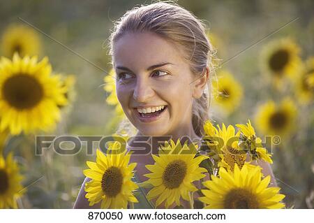 A woman in a sunflower field, portrait View Large Photo Image Stock Image - A woman in a sunflower field, portrait. Fotosearch