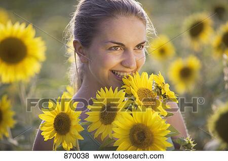 A woman in a sunflower field, portrait View Large Photo Image Stock Photo - A woman in a sunflower field, portrait. Fotosearch