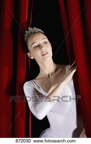 A ballet dancer peeking through a stage curtain, front view View Large Photo Image Stock Image - A ballet dancer peeking through a stage curtain, front view. Fotosearch