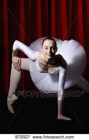 Stock Photo - A ballet dancer posing on stage. Fotosearch
