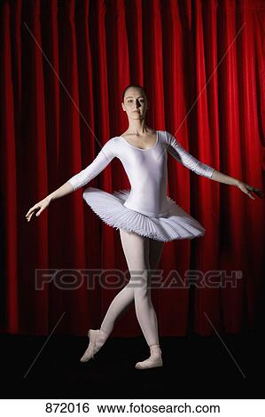 Stock Photograph - A ballet dancer posing on stage. Fotosearch